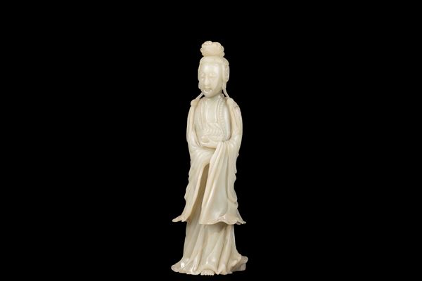 A LARGE PALE CELADON JADE FIGURE OF A STANDING GUANYIN