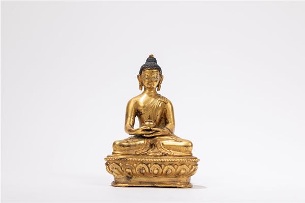 A GILT-BRONZE FIGURE OF A SEATED BUDDHA
