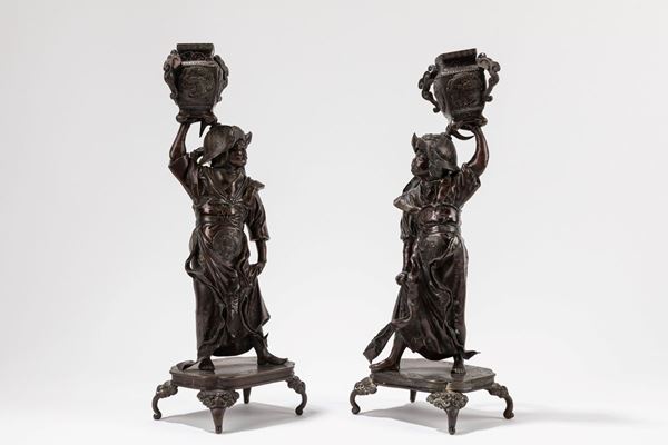 A PAIR OF BRONZE CANDLESTICKS