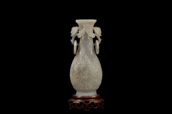 A MUGHAL STYLE CARVED CELADON JADE ELONGATED VASE