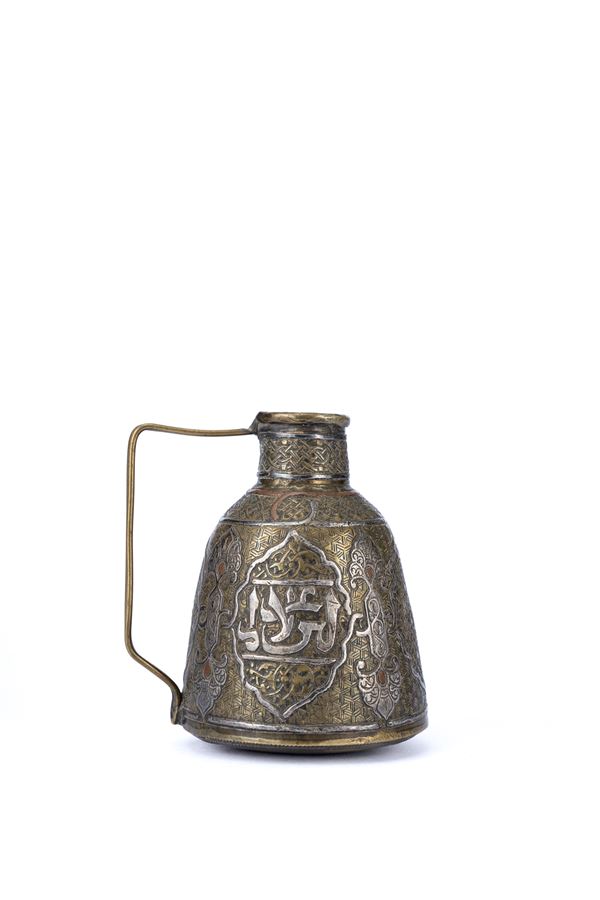 A SMALL COPPER AND SILVER INLAID SMALL JUG