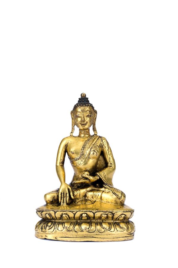 A GILT-BRONZE FIGURE OF SHAKYAMUNI