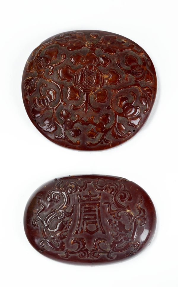 TWO AMBER PLAQUES