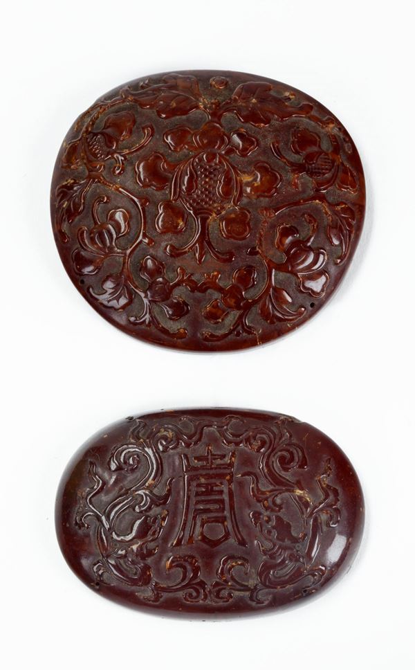 TWO AMBER PLAQUES