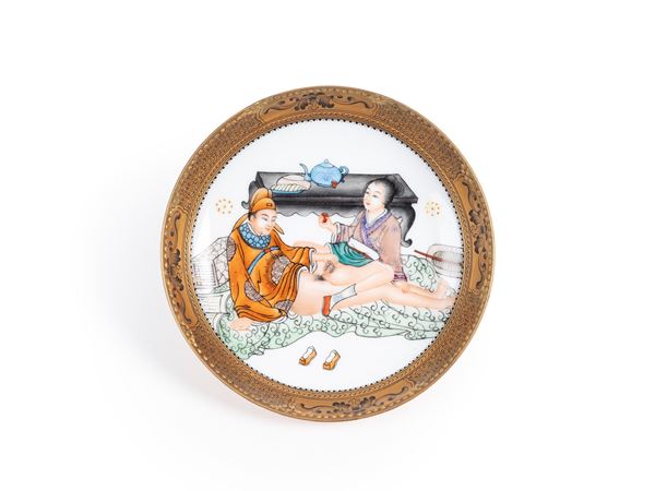 A FAMILLE ROSE GILDED EROTIC PORCELAIN PLATE