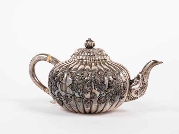 A SILVER TEAPOT