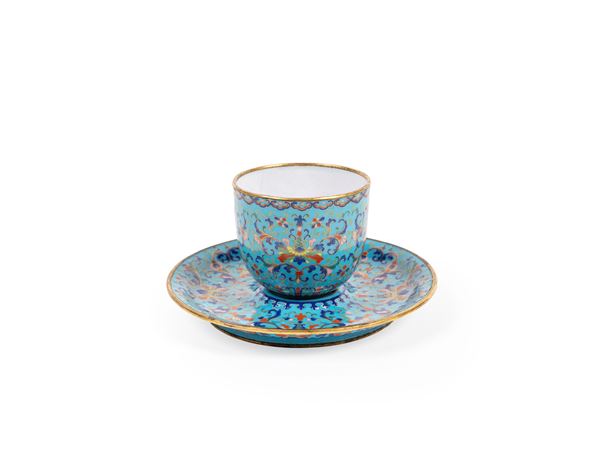 A RARE ENAMEL ON COPPER CUP AND SAUCER