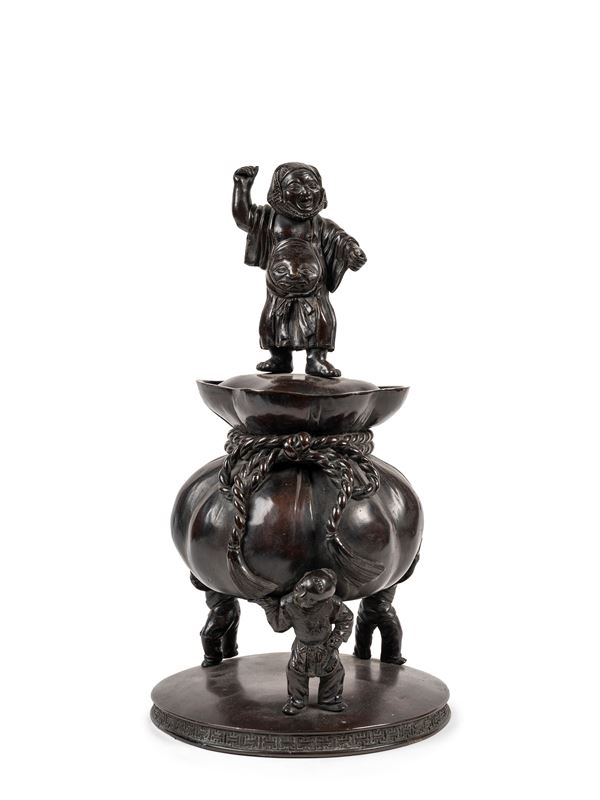 A BRONZE TRIPOD CENSER