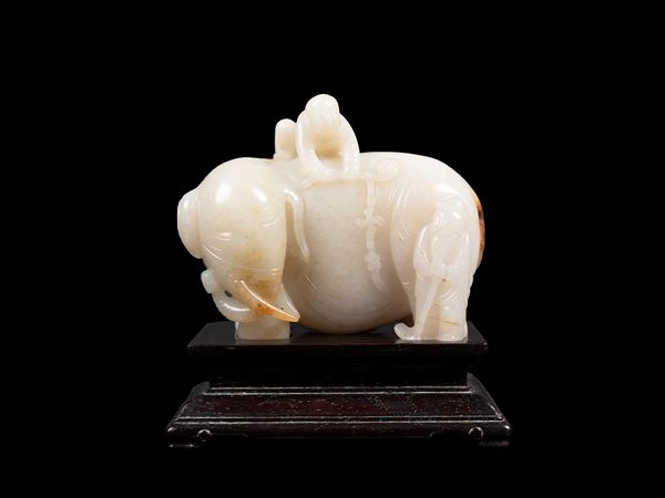 A JADE CARVING OF AN ELEPHANT WITH FIGURES