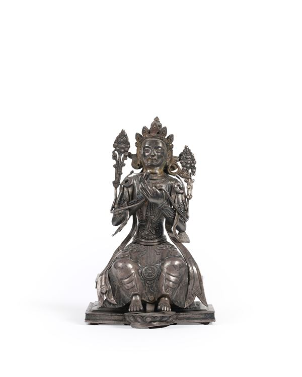 A SILVER FIGURE OF MAITREYA