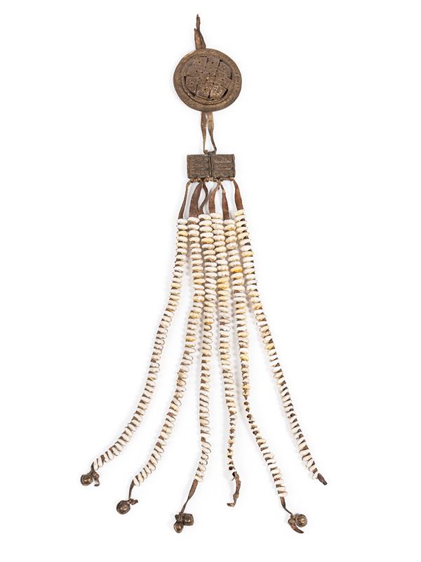 A COPPER AND SHELLS AMULET