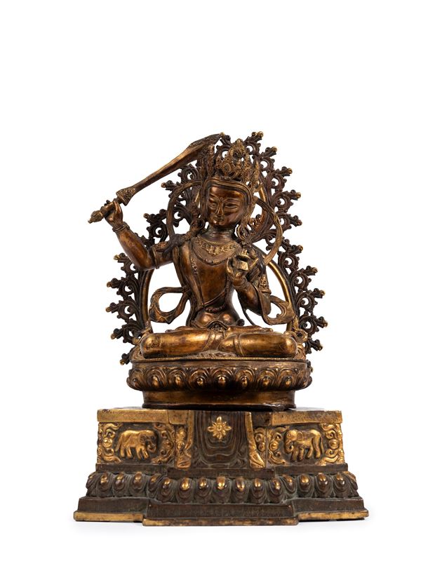 A GILT-BRONZE FIGURE OF MANJUSHRI
