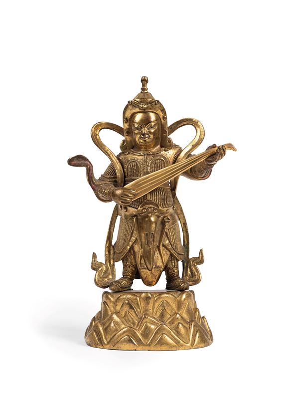 A RARE GILT-BRONZE FIGURE OF THE LOKAPALA OF THE EAST DHRITARASHTRA