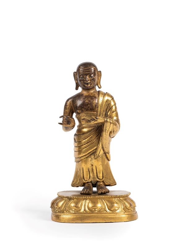 A GILT-BRONZE FIGURE OF SARIPUTRA OR MAUDGALYAYANA