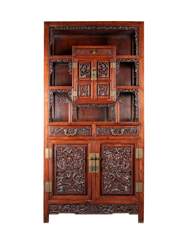A RICHLY CARVED WOOD CABINET
