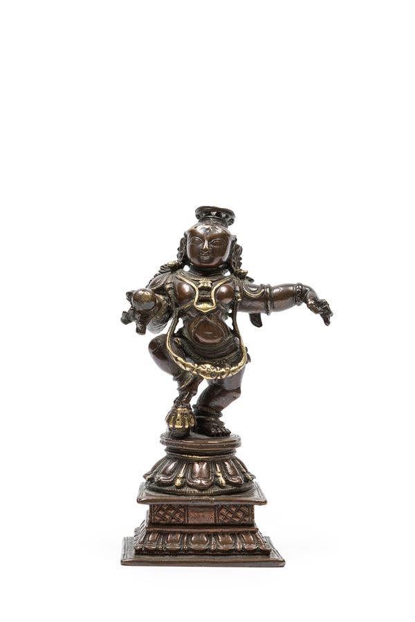 A SMALL BRONZE FIGURE OF KRISHNA