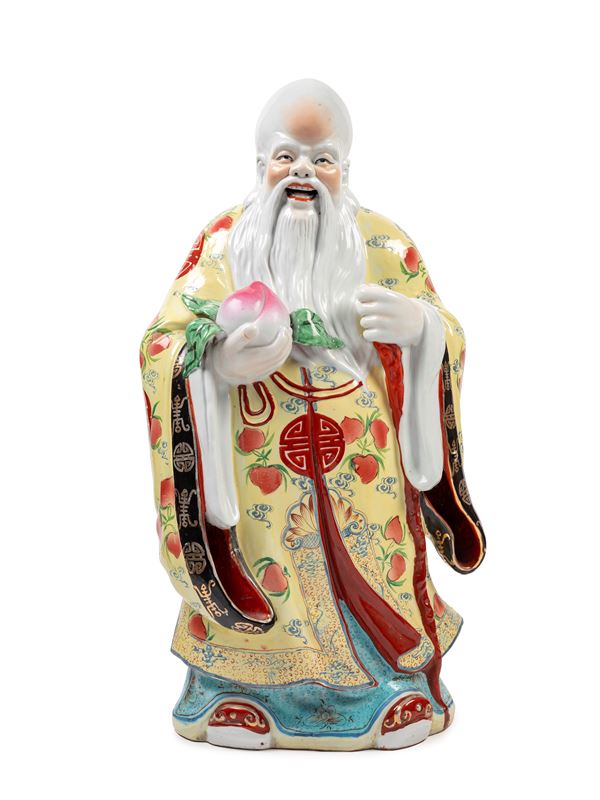 PORCELAIN SCULPTURE DEPICTING A SAGE HOLDING A PEACH