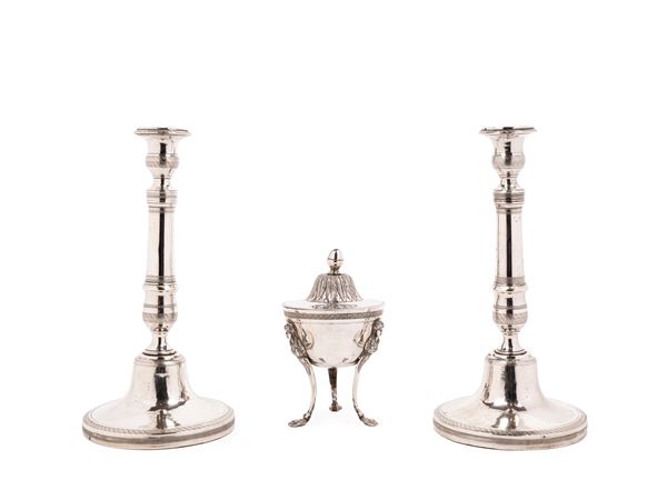 TWO CANDLESTICKS AND A SUGAR BOWL IN SILVER