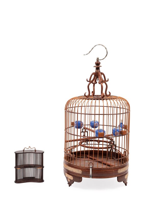 A BIRDCAGE WITH WATERPOTS