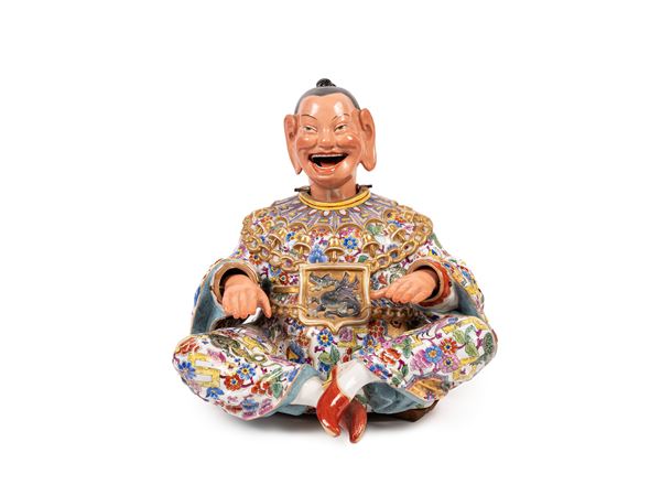 A MECHANICAL PORCELAIN MAGOT