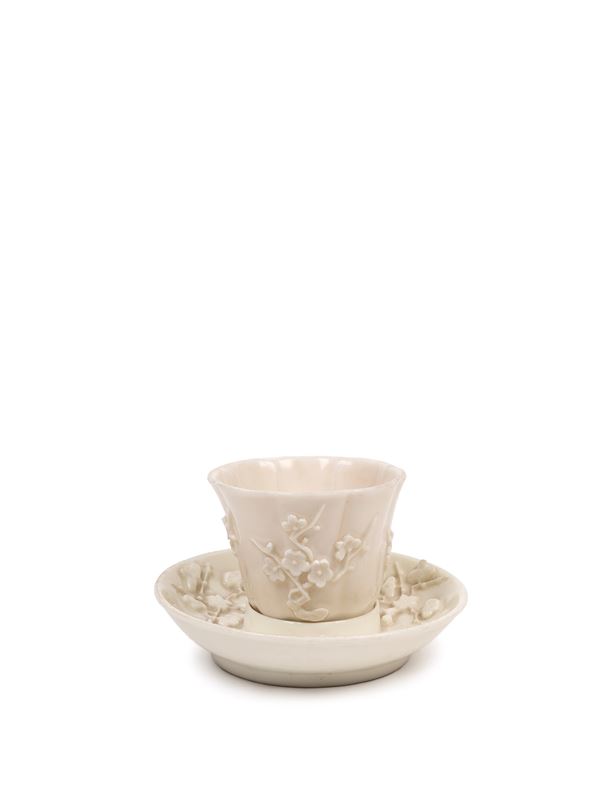 A DEHIA PORCELAIN CUP WITH SAUCER