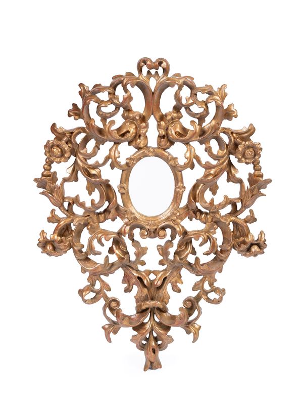 A CARVED AND GILT WOODEN FRAME