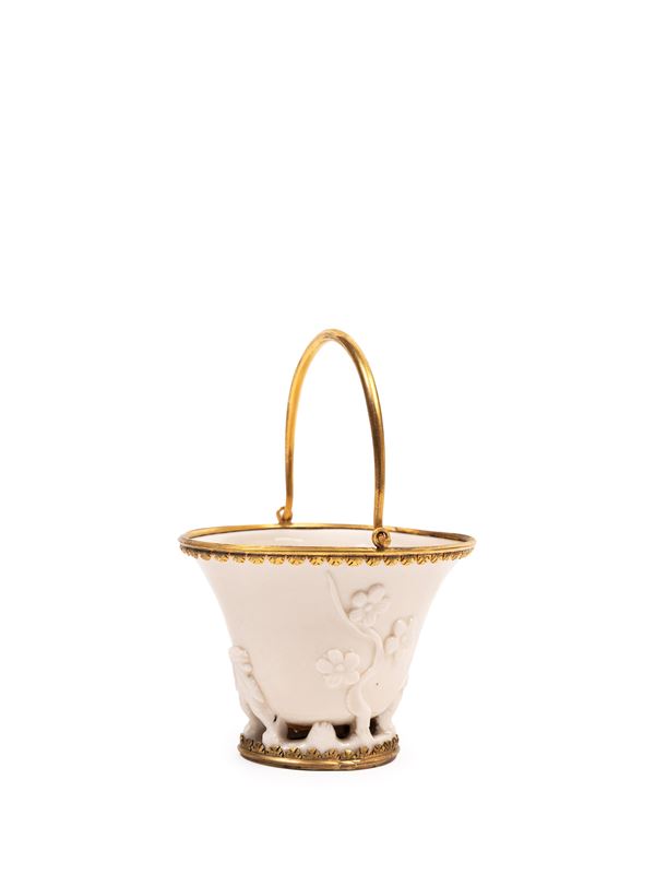 A ORMOLU MOUNTED BLANC DE CHINE PORCELAIN LIBATION CUP 