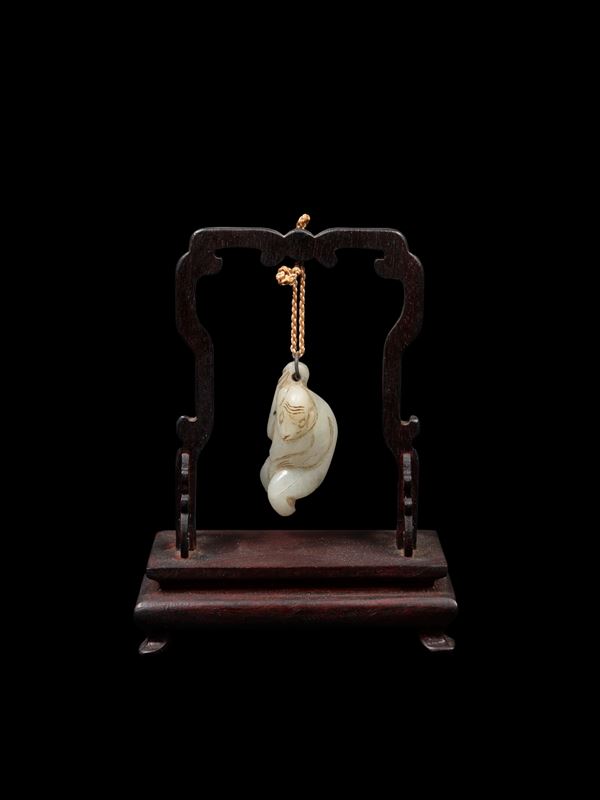 A SMALL CELADON JADE CARVING