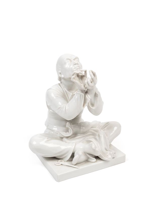 A WHITE PORCELAIN FIGURE