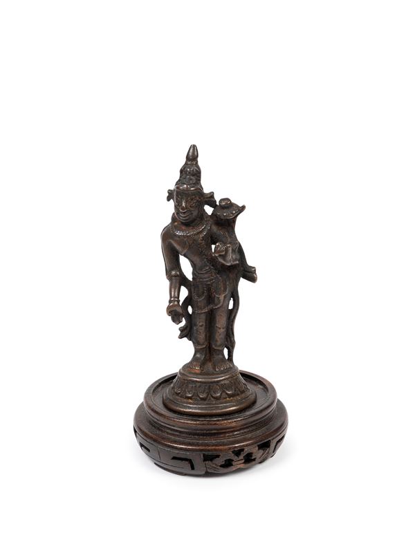 A SMALL BRONZE FIGURE