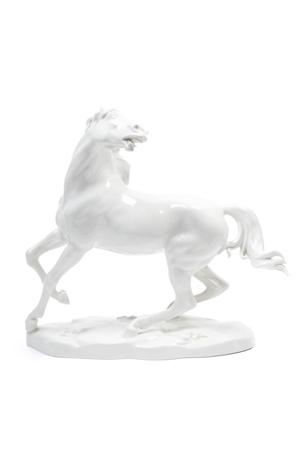 A WHITE PORCELAIN HORSE