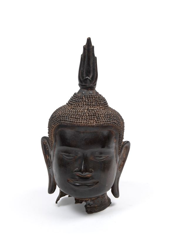 A BRONZE BUDDHA'S HEAD