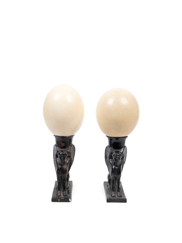 PAIR OF CERAMIC SPHINXES WITH OSTRICH EGGS