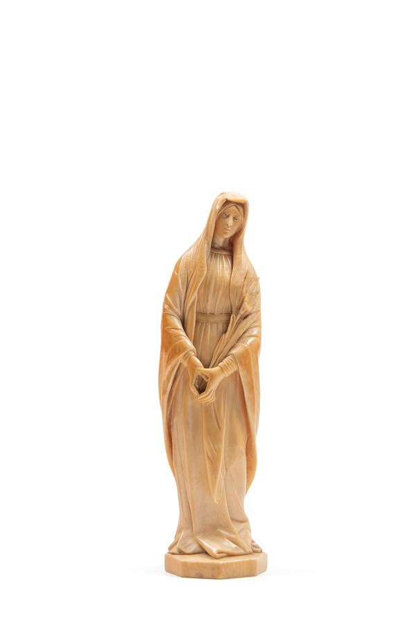 ☼IVORY SCULPTURE DEPICTING A SAINT WITH A LILY