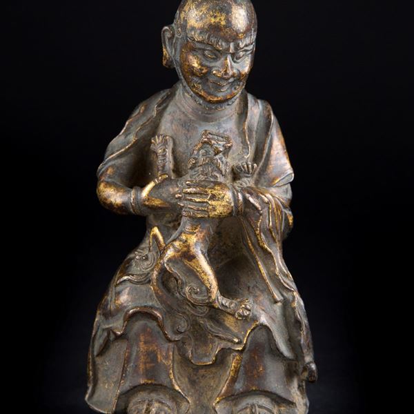 A SMALL GILT-BRONZE FIGURE