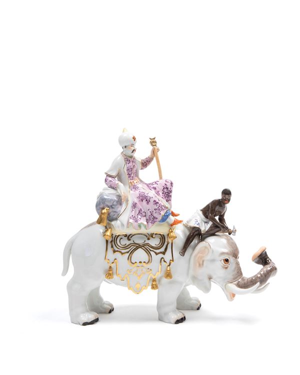 POLYCHROME PORCELAIN SCULPTURE DEPICTING A SULTAN WITH ATTENDANT ON AN ELEPHANT