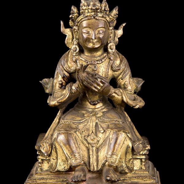 A GILT BRONZE SEATED BUDDHA