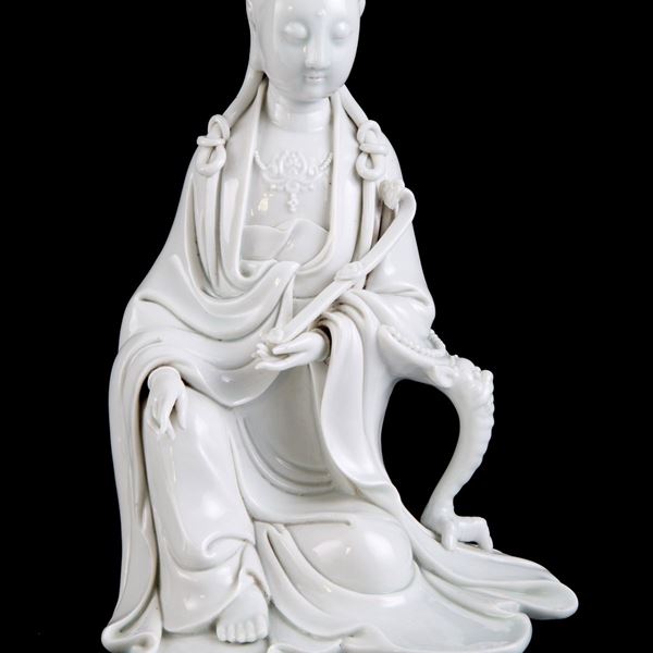 A FIGURE OF A DEHUA SEATED GUANYIN MARKED