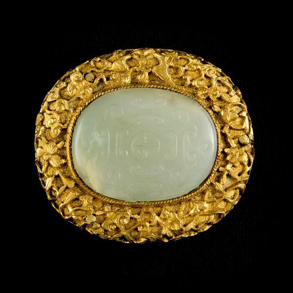 A GILT-BRONZE BRONZE AND JADE BUCKLE