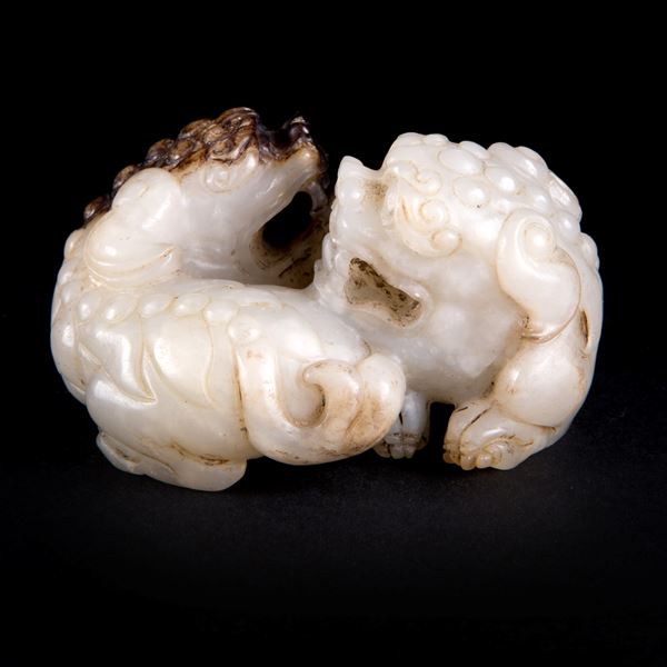 A PALE CELADON AND BROWN JADE 'LIONS' GROUP