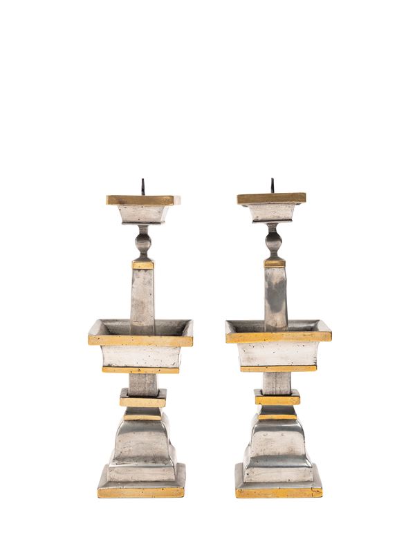 A PAIR OF METAL CANDLE HOLDERS