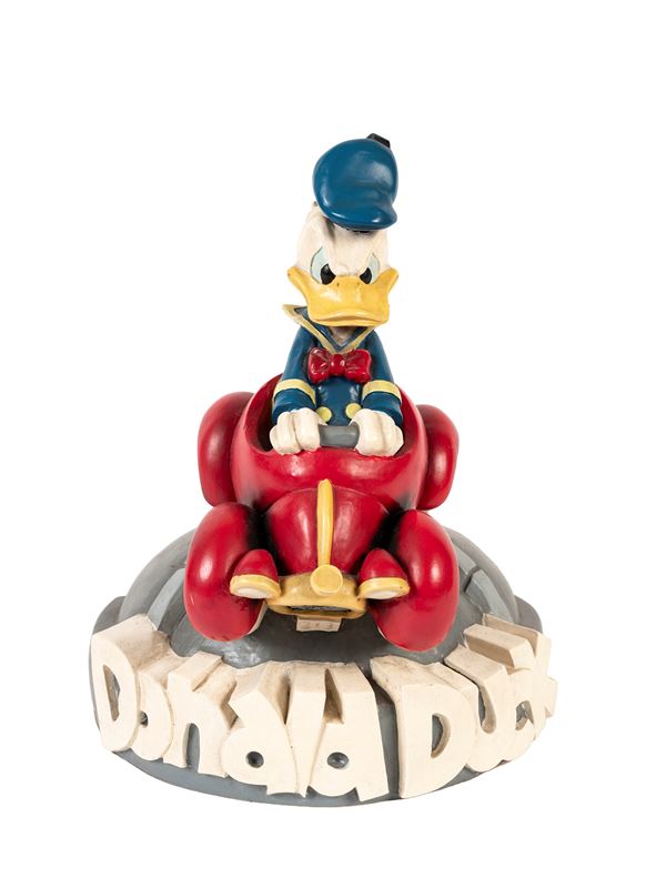 A DONALD DUCK (PAPERINO) FIGURE ON A CAR, WALT DISNEY