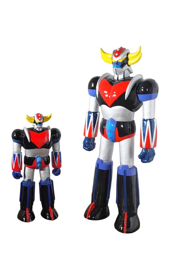 A PAIR OF GOLDRAKE FIGURE STATUES