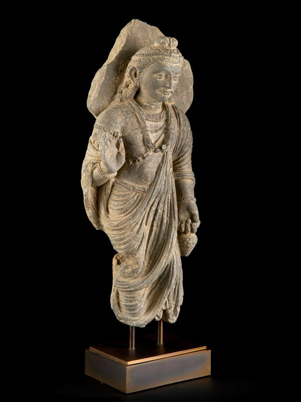 A BODHISATTVA MAITREYA FIGURE IN SCHIST