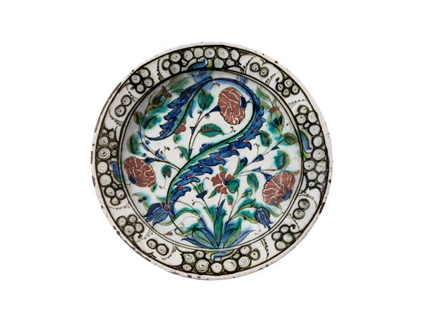AN IZNIK POTTERY 'STORM IN A TEACUP' DISH