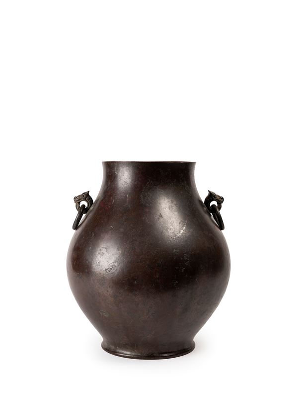 A TWO-HANDLED BRONZE VASE
