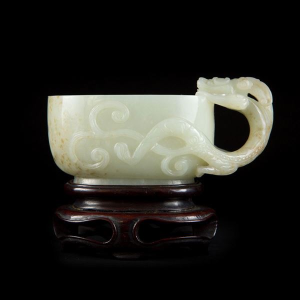 A PALE CELADON JADE ‘QILONG’ LIBATION CUP