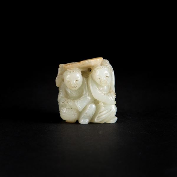 A CARVED CELADON JADE