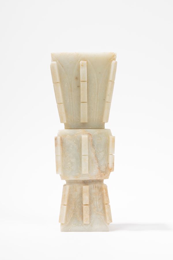 AN ARCHAISTIC MOTTLED WHITE JADE ZUN FORM VASE