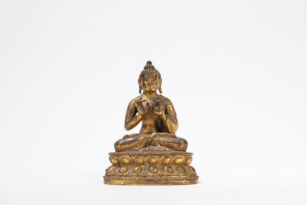 A GILT-BRONZE FIGURE OF A SEATED BUDDHA